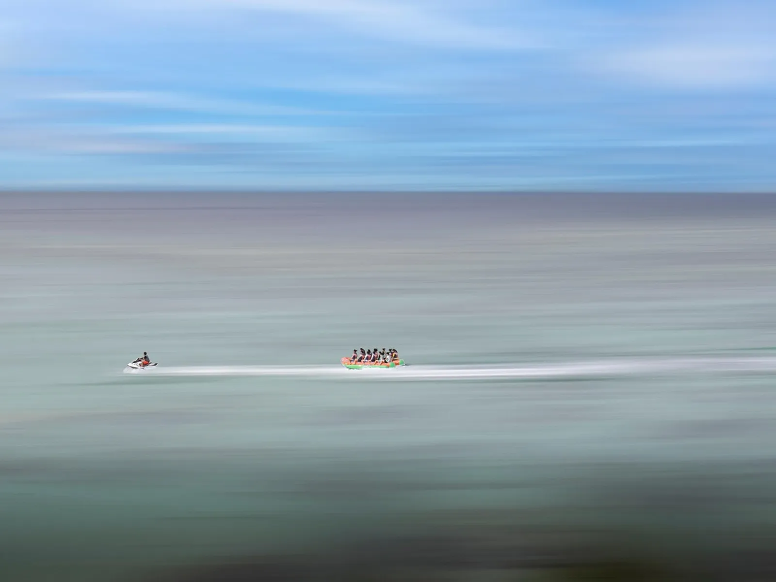 Boat towing an inflatable on the open sea