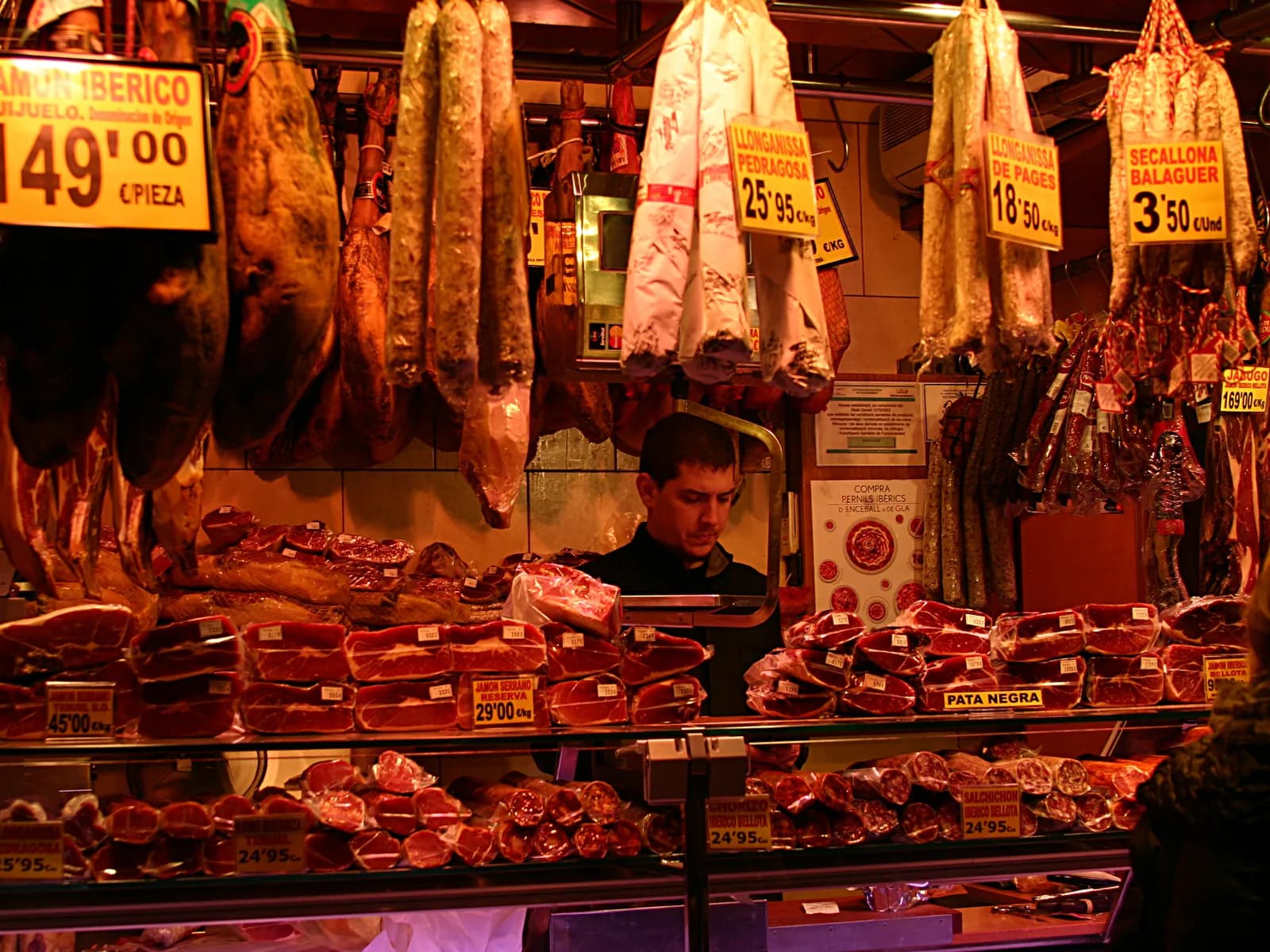 Stall with Iberian hams and cured meats at La Boqueria market
