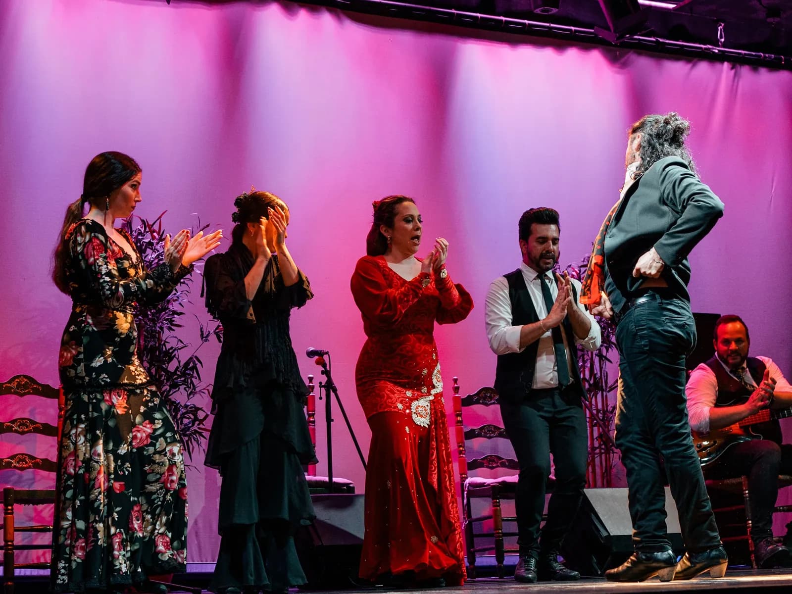 Singers, dancers and guitarist on stage at the City Hall Theatre