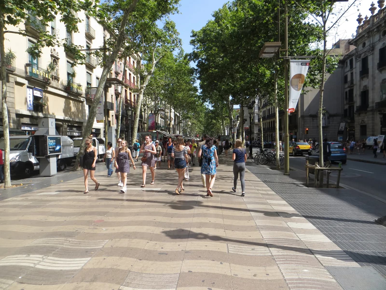 Walkers on the wave-patterned pavement of La Rambla