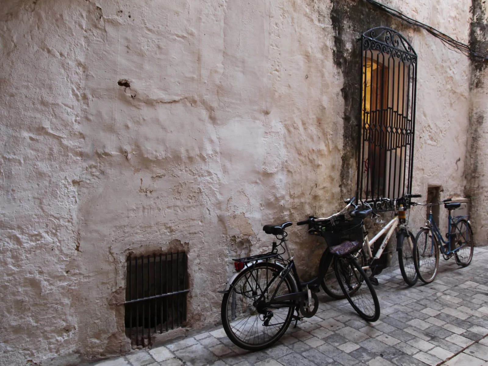 Bicycles parked by a whitewashed facade on an Andalusian street