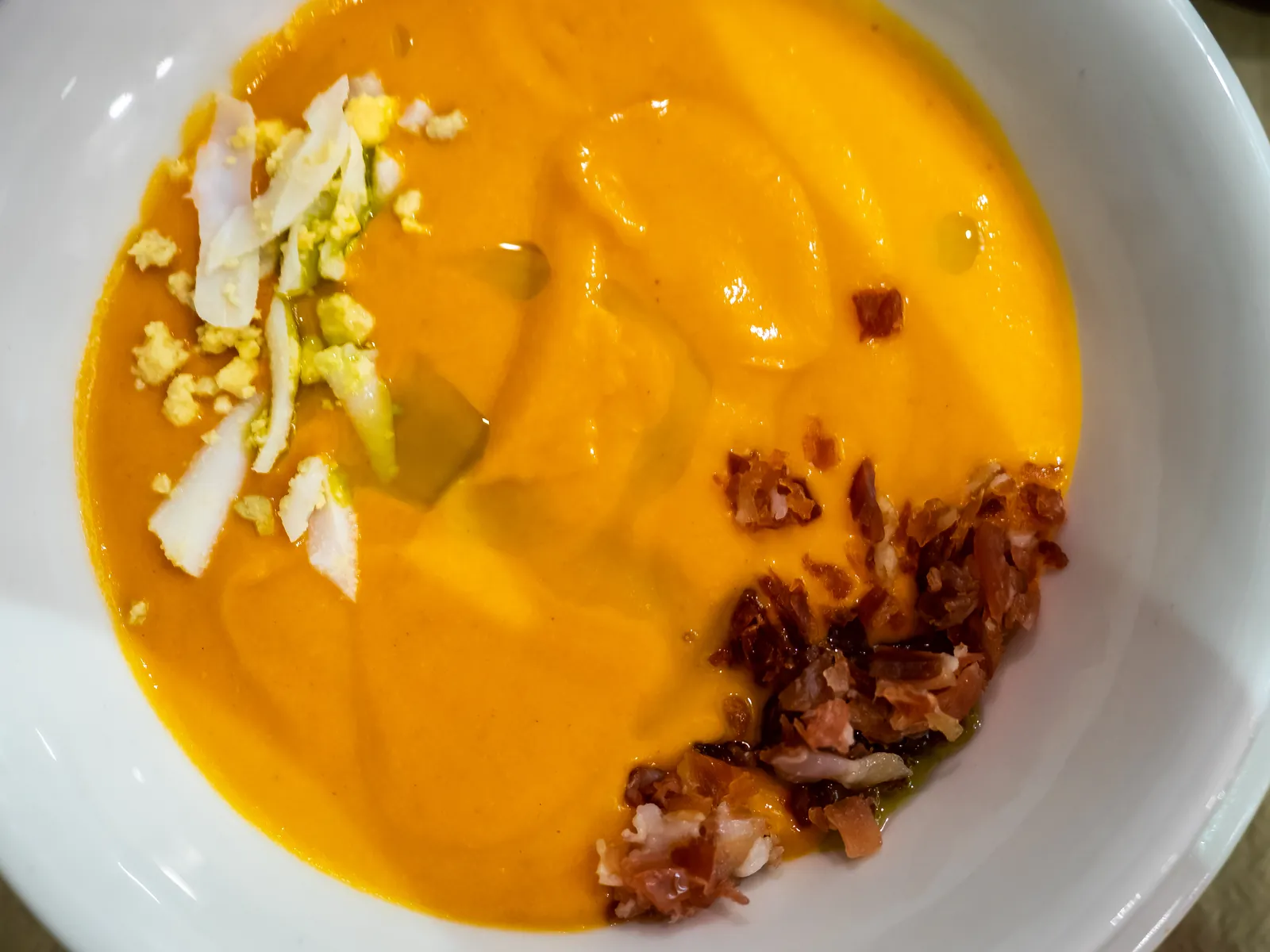 Bowl of Cordoban salmorejo with hard-boiled egg and ham in Córdoba