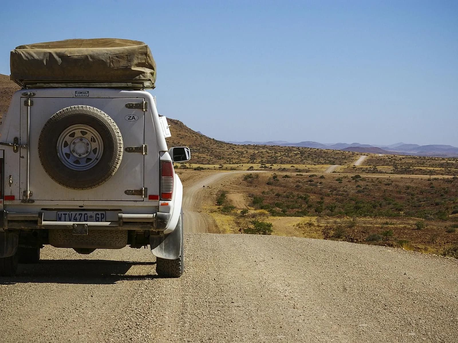 4x4 driving along a dirt track among mountains