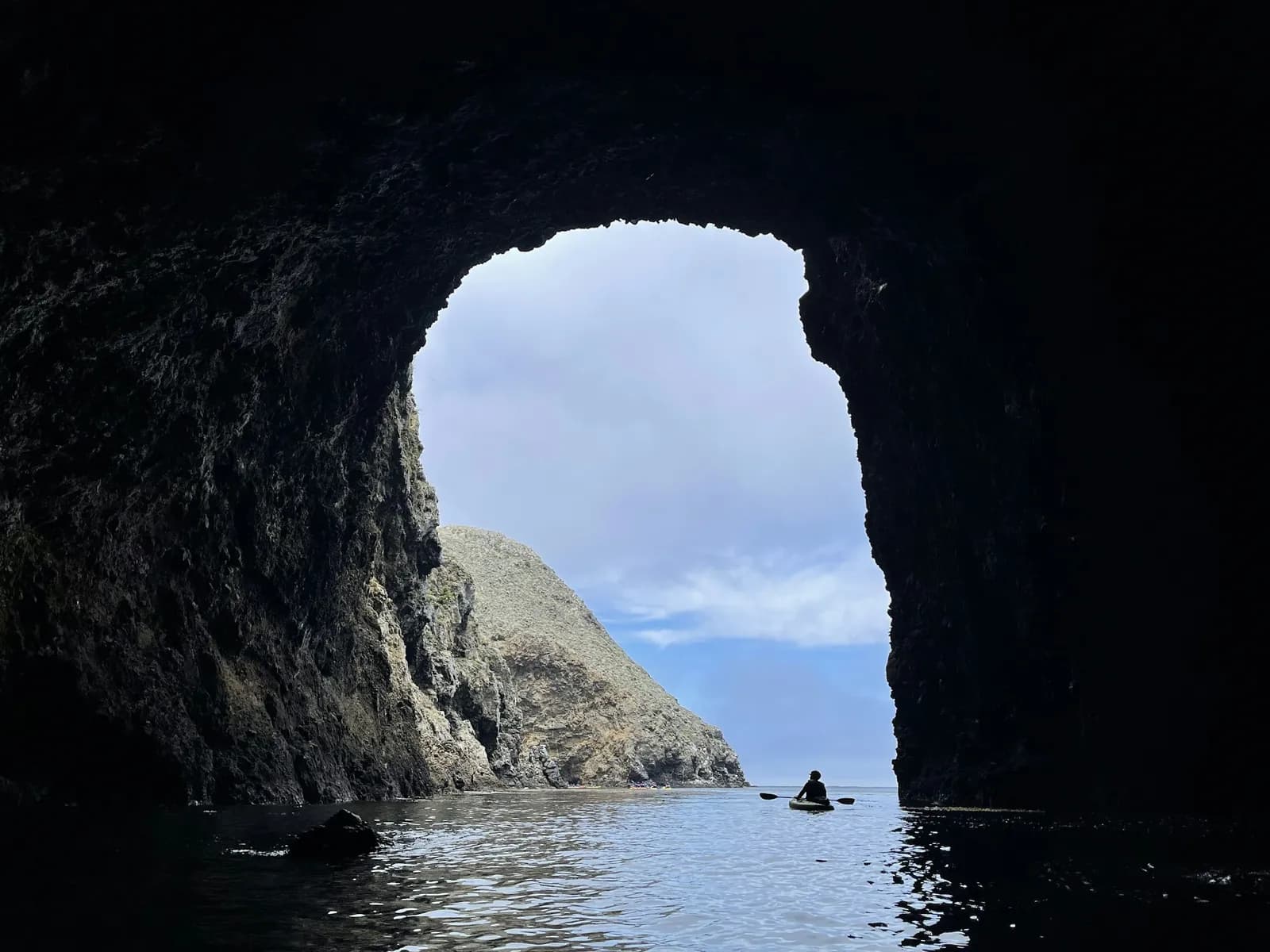 A kayak at the mouth of a sea cave