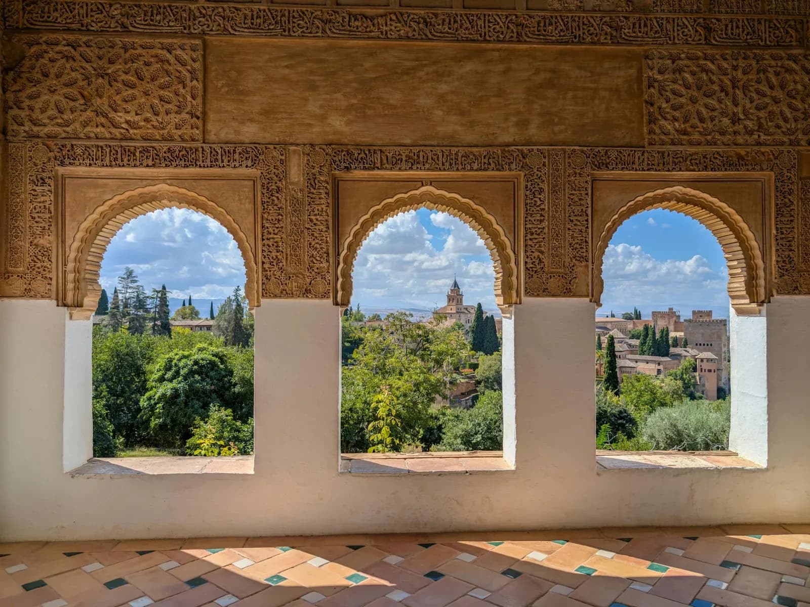 Courtyard of the Alhambra with palm trees reflected in a water channel