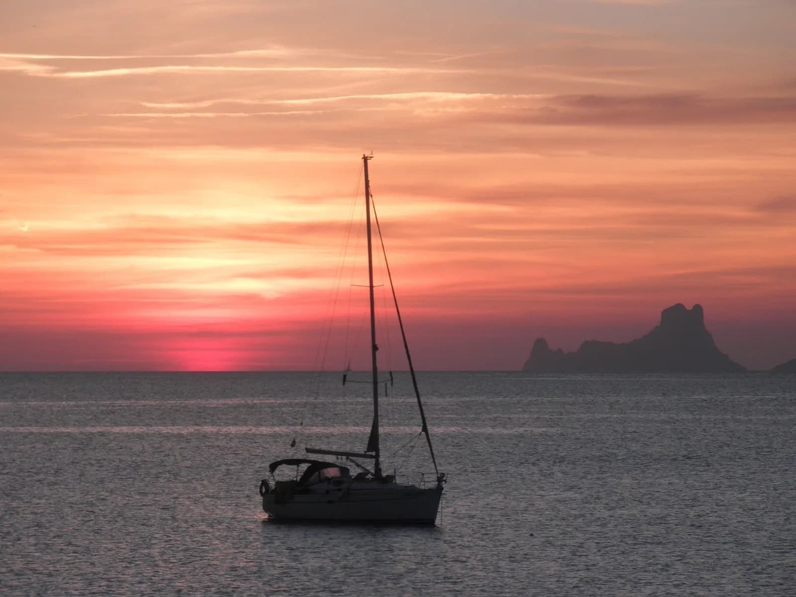 A sailing boat at sunset off Ibiza