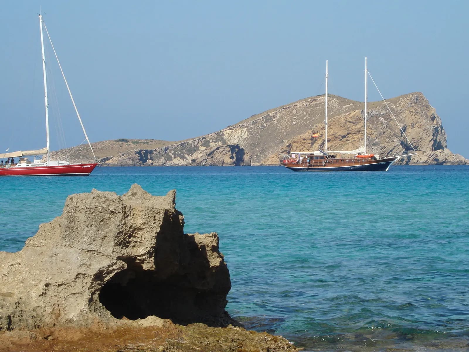 Sailing boats off Cala Comte