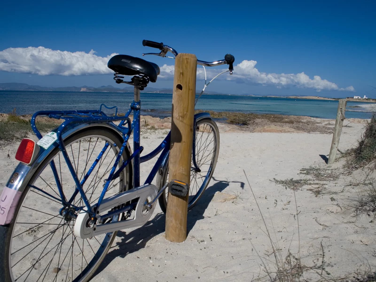 Bicycle parked by Ses Illetes beach, Formentera