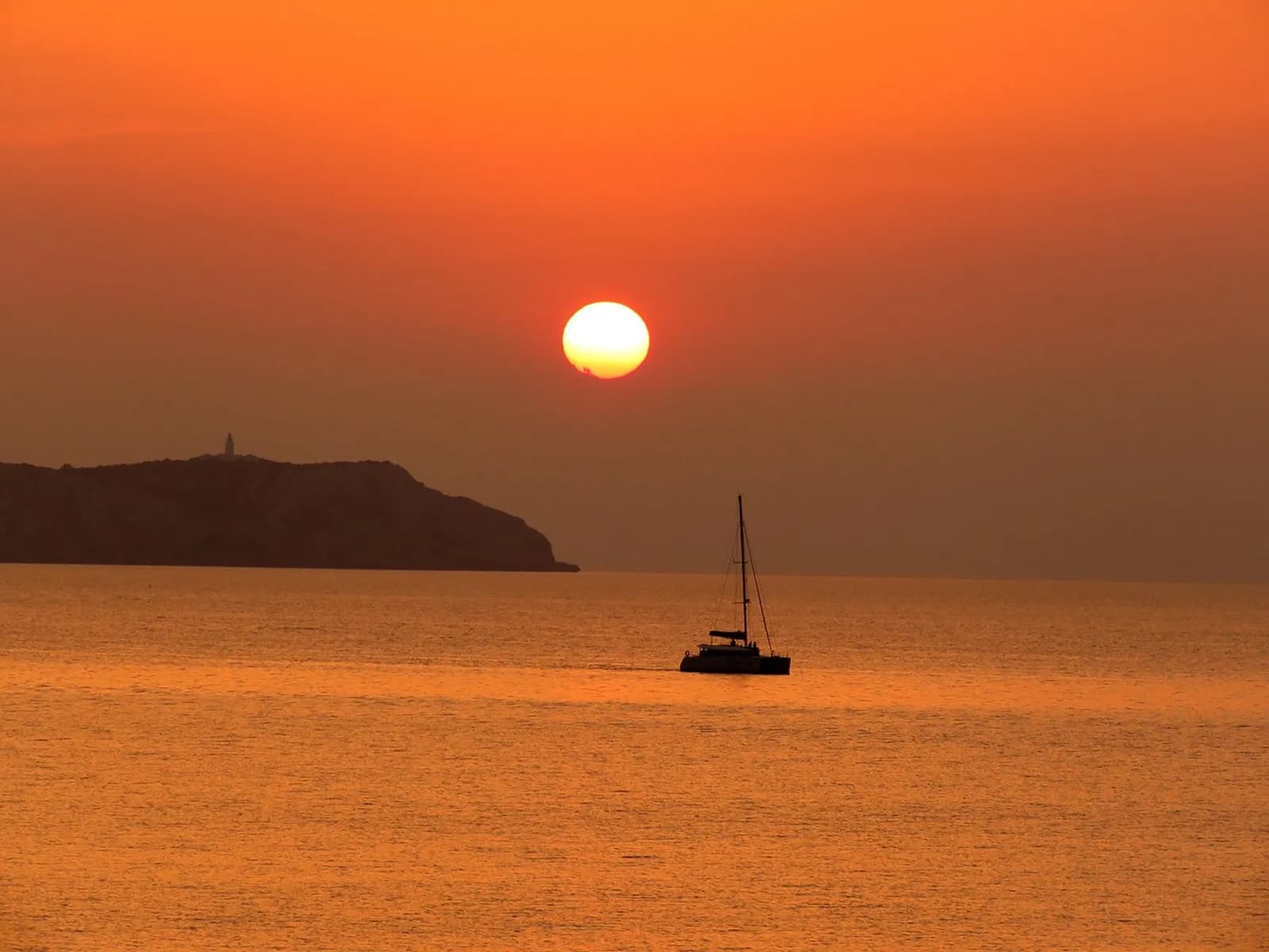 Sailboat at sunset off Sa Conillera island, Ibiza
