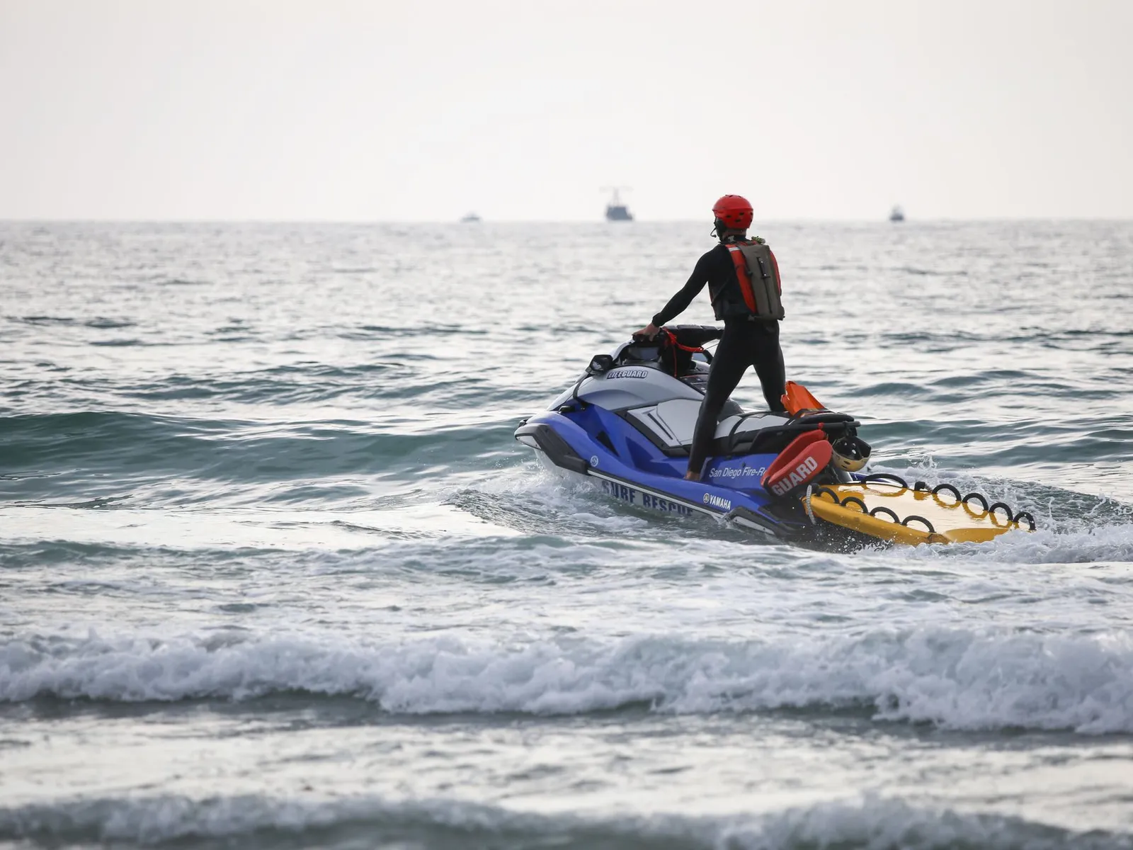 Jet ski riding through waves