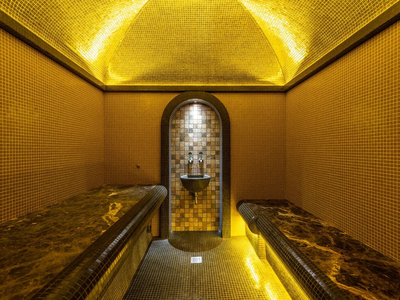 Arab-inspired bath hall with warm lighting