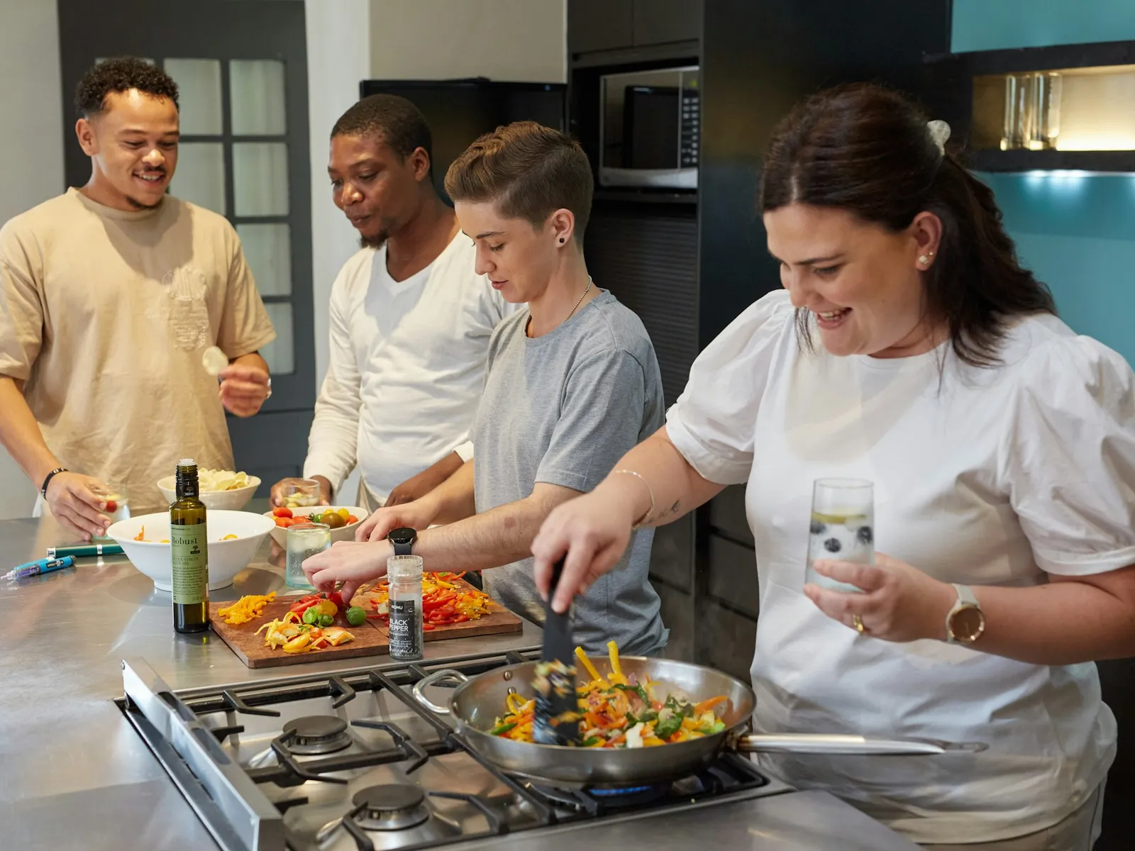 Students cooking with the chef in a Spanish cooking class