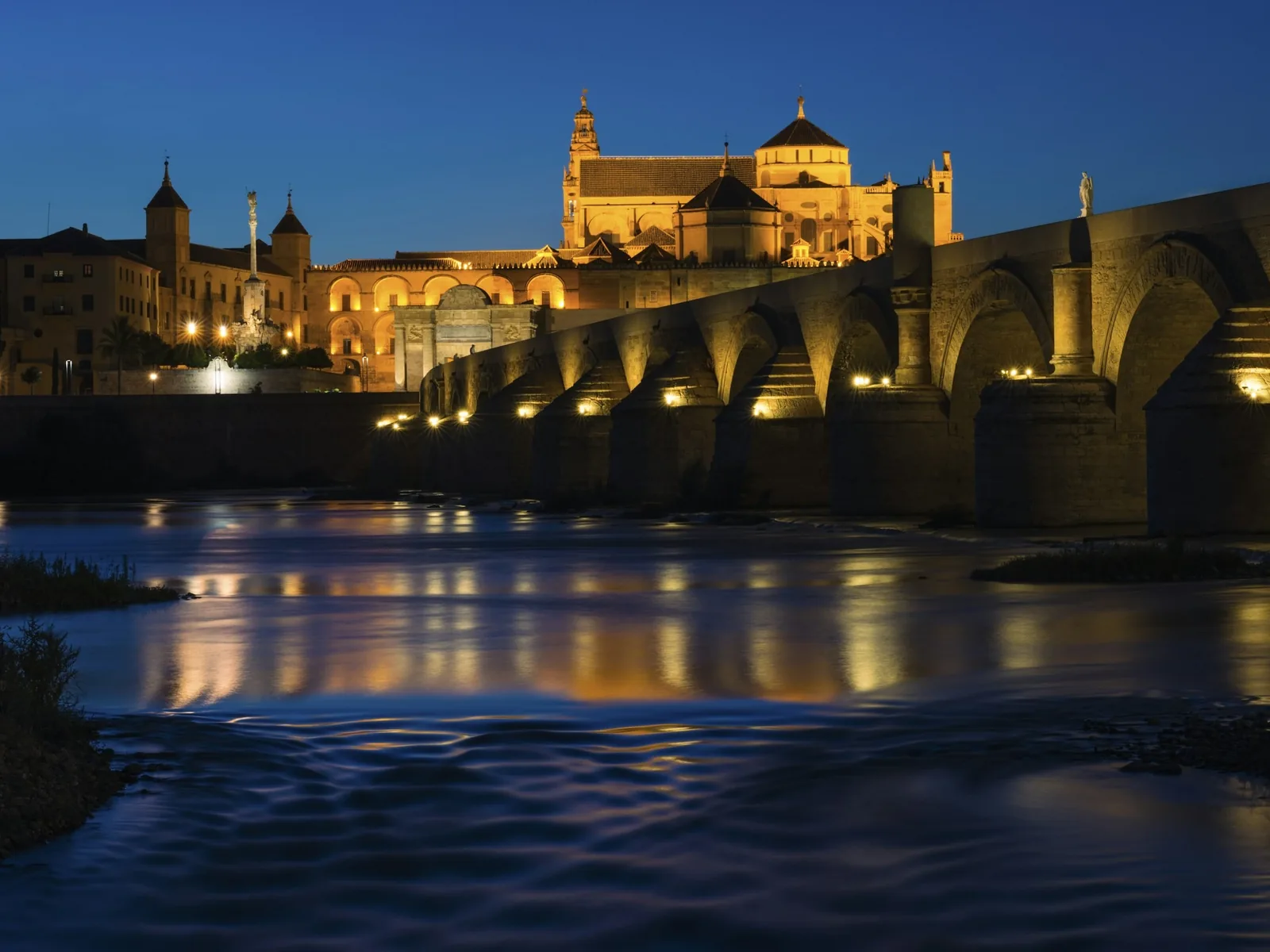 Córdoba's Roman bridge and Mosque-Cathedral lit up at night