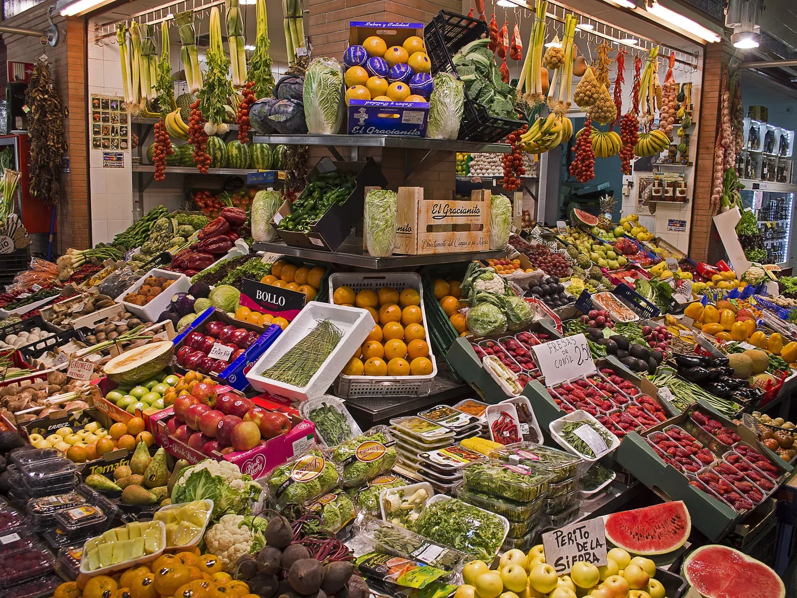 Fruit and vegetable stall piled high at the Triana market