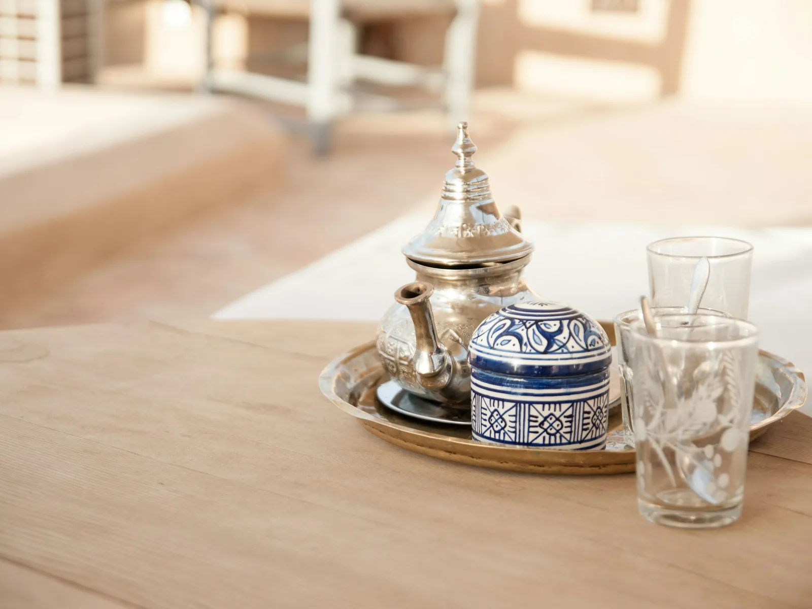 Moroccan mint tea in traditional metal glasses at medina market stall, Seville's old town atmosphere