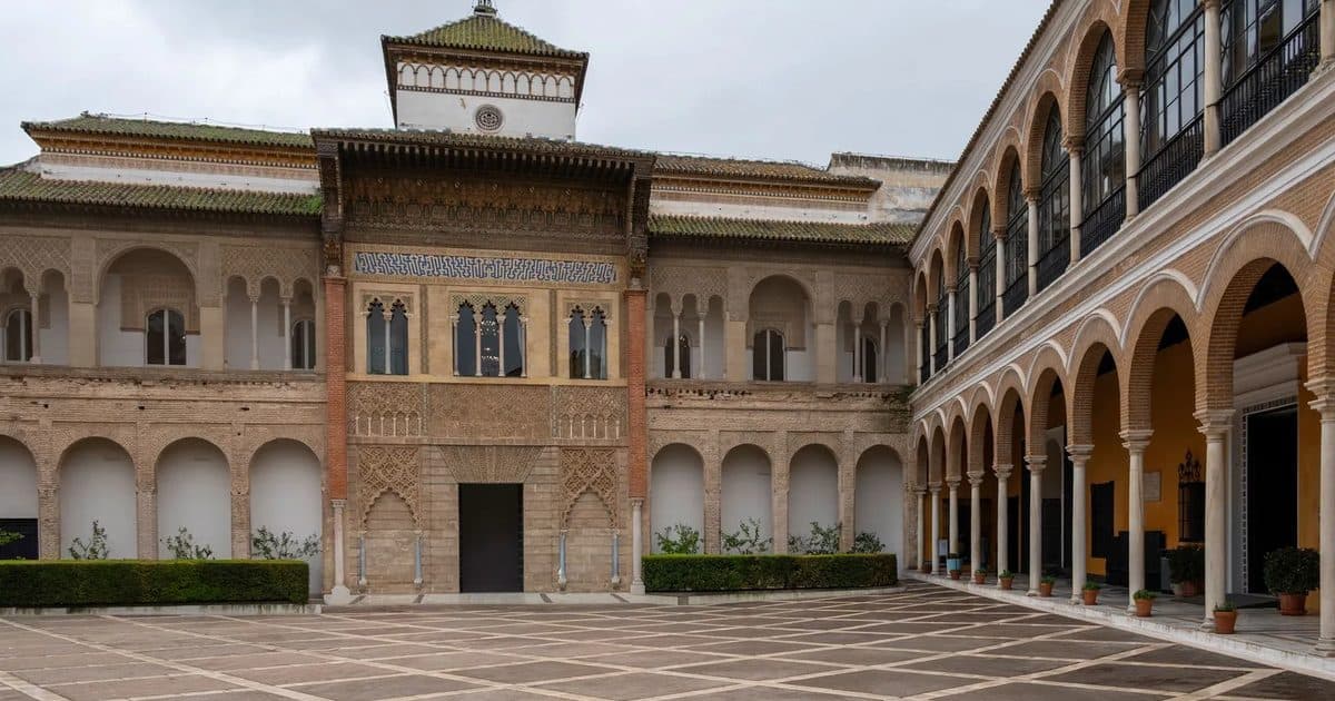 Courtyard of the Maidens in the Royal Alcázar of Seville, with its long reflecting pool between Mudéjar arches