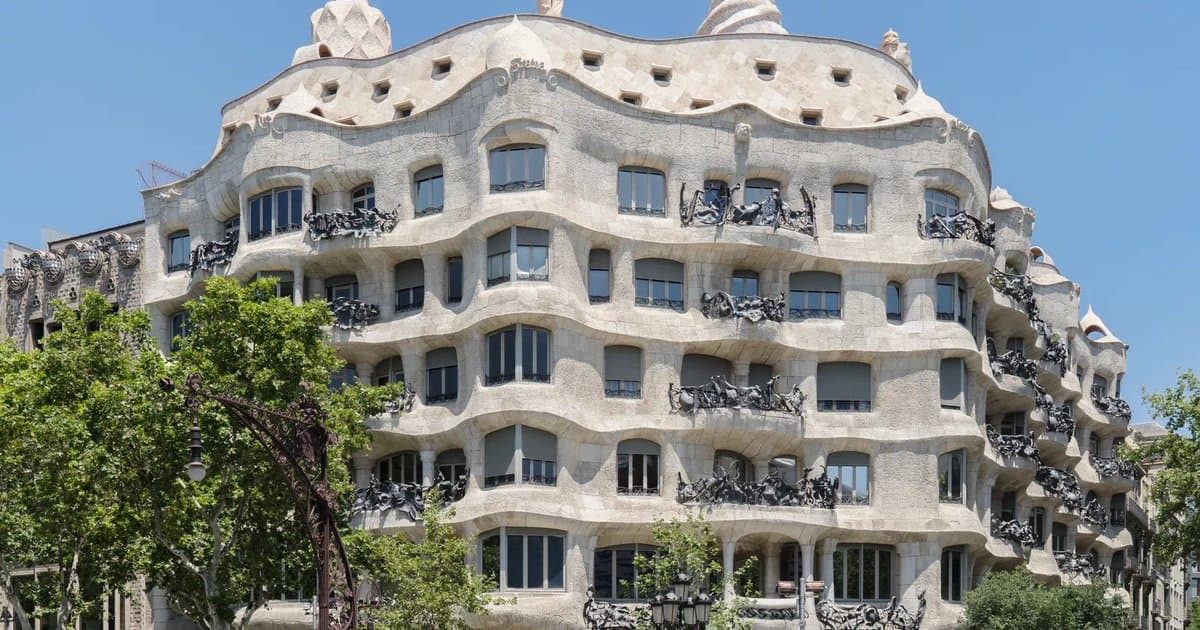 Undulating stone façade of Gaudí's La Pedrera (Casa Milà) on Passeig de Gràcia in Barcelona, with its wrought-iron balconies