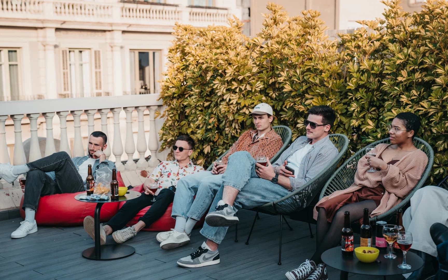 Group relaxing with beers on a Barcelona rooftop