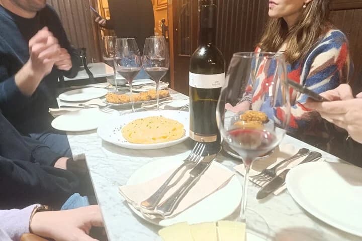Table with dishes, glasses and wine during the tour