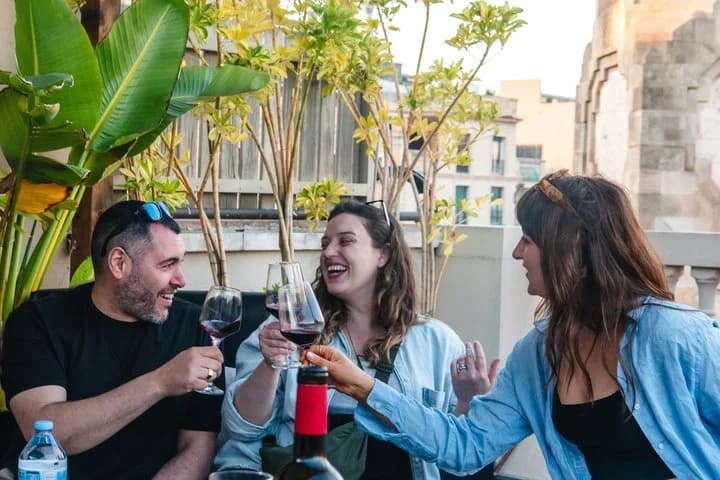 Group toasting with wine on a Barcelona rooftop