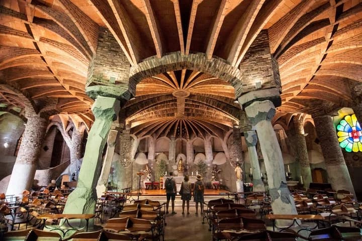 Inside the Colonia Güell crypt, with its leaning columns and brick vaults